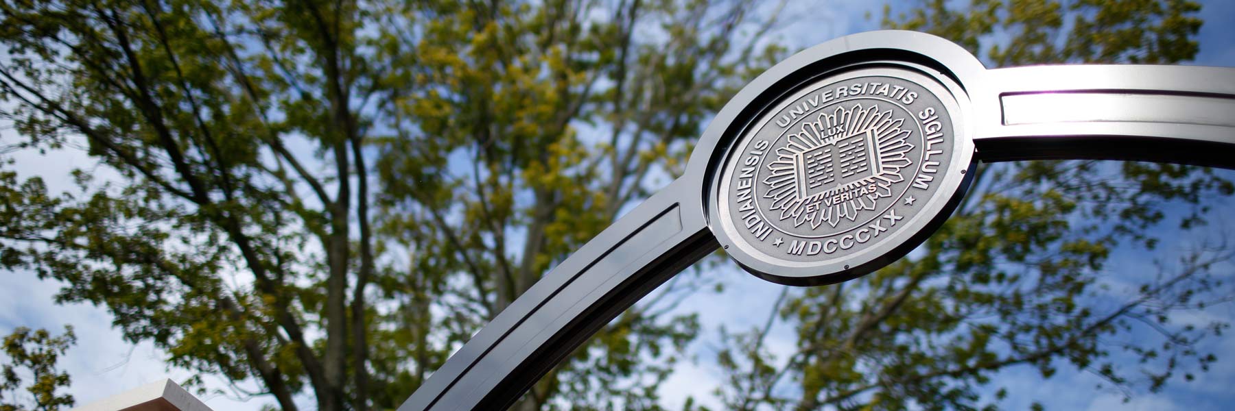 The Indiana University seal adorns a campus gateway.
